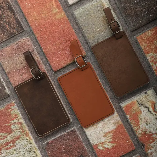 Leather luggage tags in brown colors. Concept shot, top view. Custom background, luggage tags view. Empty Travel Luggage Label, Space blank for text.