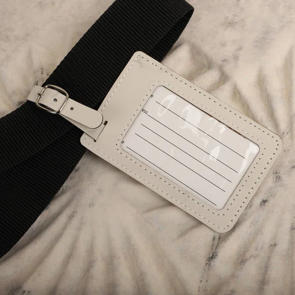Leather luggage tags in white colors. Concept shot, top view. Custom background, luggage tags view. Empty Travel Luggage Label, Space blank for text.