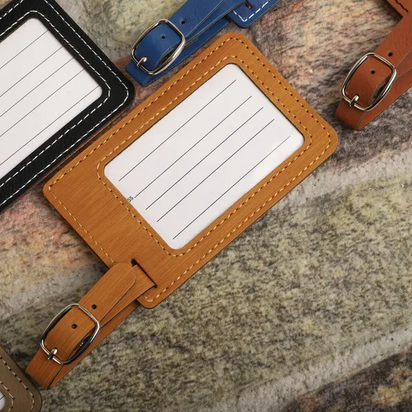 Leather luggage tags in bamboo colors. Concept shot, top view. Custom background, luggage tags view. Empty Travel Luggage Label, Space blank for text.