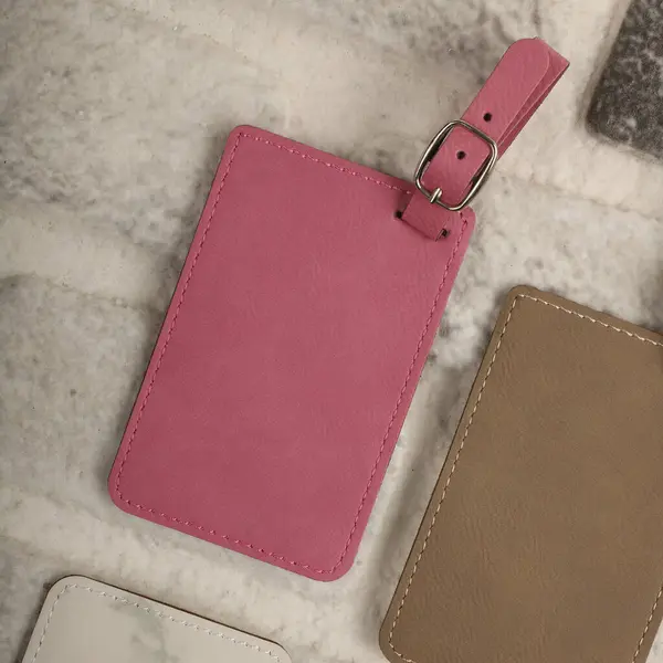 Leather luggage tags in pink colors. Concept shot, top view. Custom background, luggage tags view. Empty Travel Luggage Label, Space blank for text.