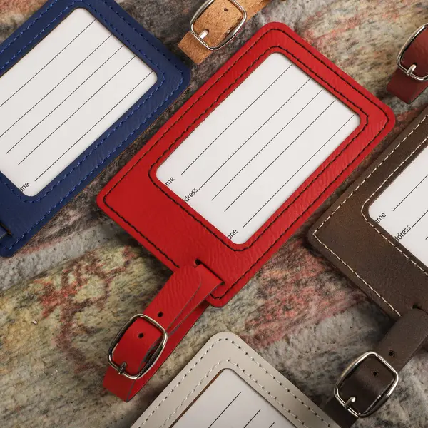 Leather luggage tags in different colors. Concept shot, top view. Custom background, luggage tags view. Empty Travel Luggage Label, Space blank for text.