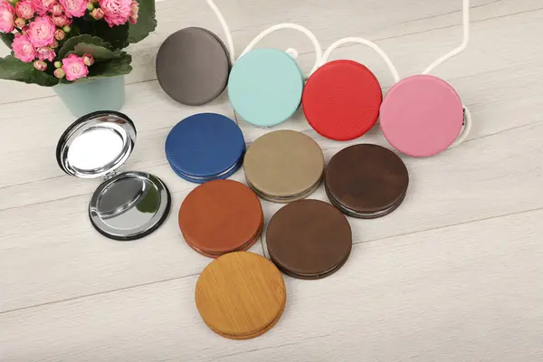 Leather Round pocket makeup mirror in different colors. Concept shot, top view. Custom background, pocket makeup mirror. Travel pocket mirror,  Colorful mini mirror.