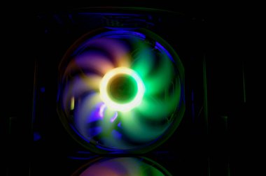 Computer cooler with RGB LED light. Computer circuit board and CPU cooling fans illuminated 