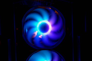 Colorful bright rainbow led rgb pc fan air case cooler. Computer chassis. Gaming modding, technology concept and IT background.