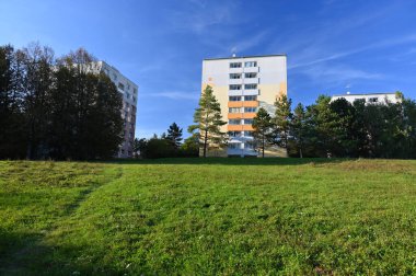 Original prefabricated houses on a housing estate from the communist era in Eastern and Central Europe after reconstruction.. Facade of a modern apartment building with windows and balconies. Czech Republic - Europe. clipart