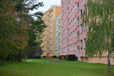 Original prefabricated houses on a housing estate from the communist era in Eastern and Central Europe after reconstruction.. Facade of a modern apartment building with windows and balconies. Czech Republic - Europe. clipart