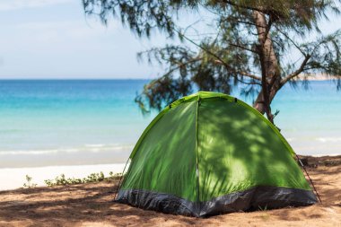 Tourist tent on the seashore. Against the backdrop of the sea.