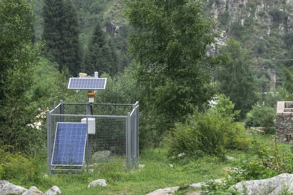 Mini substation with solar panels. Mountain landscape