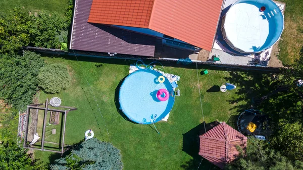 Frame pool in the backyard of the house. View from the drone