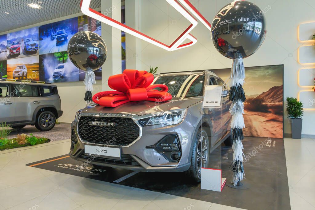 Almaty, Kazakhstan - June 11, 2025: New Jetour X70 car with a gift bow on the hood. Chinese automaker
