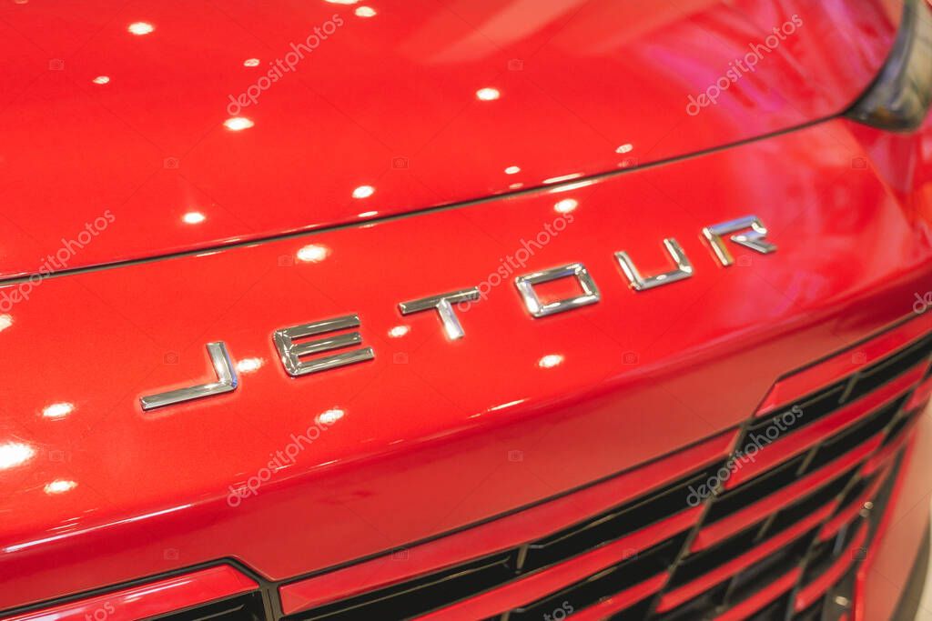 Almaty, Kazakhstan - June 11, 2025: Jetour emblem on the front hood of a red car. Chinese automaker