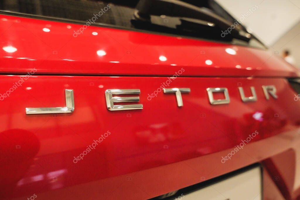 Almaty, Kazakhstan - June 11, 2025: Jetour emblem on the rear trunk of a red car. Chinese automaker