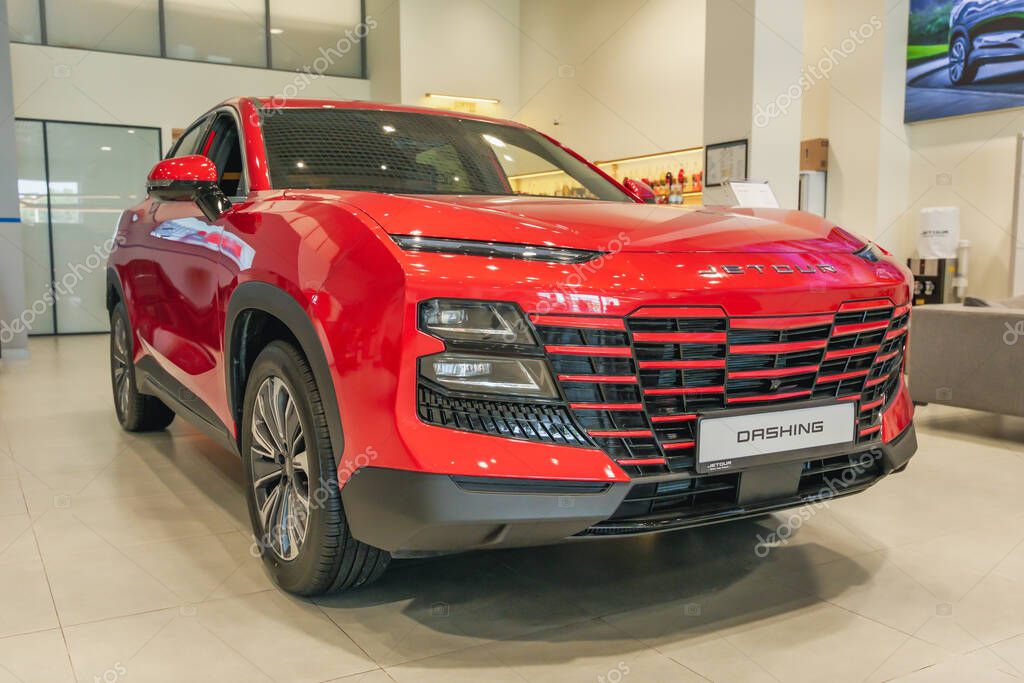Almaty, Kazakhstan - June 11, 2025: Red Jetour Dashing car in a showroom. Chinese automaker