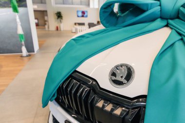 Almaty, Kazakhstan - June 11, 2025: Skoda car emblem on the hood. Retail trade in the showroom                            