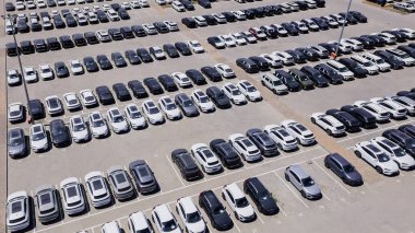 Almaty, Kazakistan - 3 Temmuz 2025: Dağıtımcının otoparkında farklı markalardan yeni arabaların sıraları. Elektrikli araç. Üst görünüm