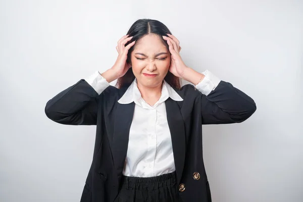 stock image A portrait of an Asian business woman wearing a black suit isolated by white background looks depressed