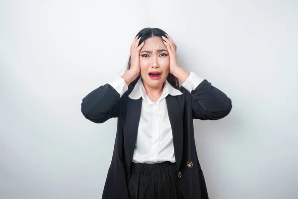 stock image A portrait of an Asian business woman wearing a black suit isolated by white background looks depressed