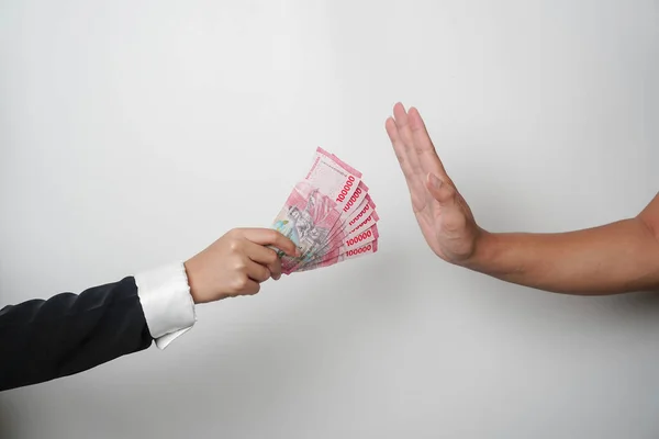 stock image A portrait of businessman refusing money, Indonesian rupiah bills - anti-bribery and corruption concepts