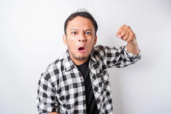 stock image The angry and mad face of Asian man in tartan shirt on isolated white background.