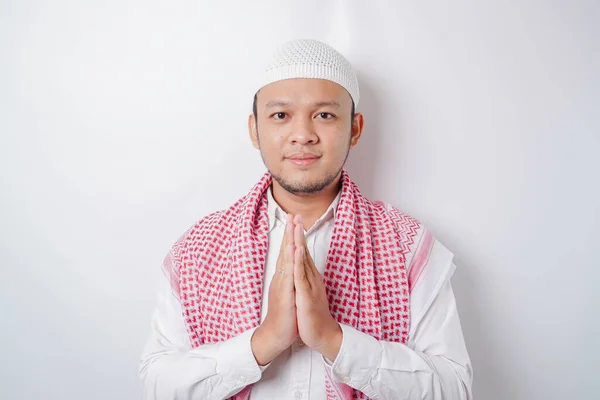 stock image Smiling young Asian Muslim man, gesturing traditional greeting isolated over white background