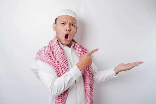 Schockierter Asiatischer Muslim Zeigt Auf Den Kopierraum Neben Ihm Isoliert — Stockfoto