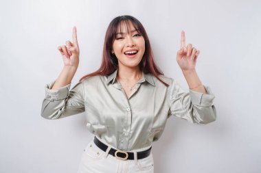 Heyecanlı Asyalı, yeşil tişörtlü, beyaz arka planla izole edilmiş fotokopi odasını gösteren bir kadın.