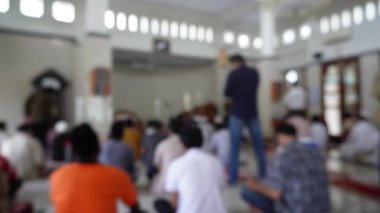 Bulanık arkaplan İslamcı erkekler cuma günü camide namaz kılıyor. Camide toplanıyorlar.. 