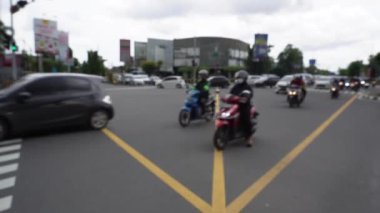 Blurry Background of Car intersection traffic in red and green light in Yogykarta, Indonesia