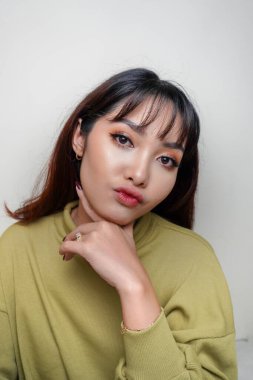 A beauty cheerful face of Asian young model wearing green top. Skincare beauty facial treatment, spa, female health concept.
