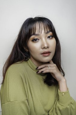 A beauty cheerful face of Asian young model wearing green top. Skincare beauty facial treatment, spa, female health concept.