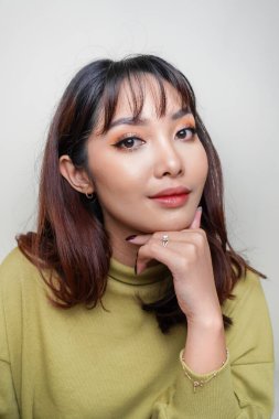 A beauty cheerful face of Asian young model wearing green top. Skincare beauty facial treatment, spa, female health concept.