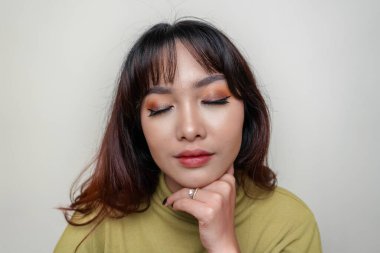 A beauty cheerful face of Asian young model wearing green top. Skincare beauty facial treatment, spa, female health concept.