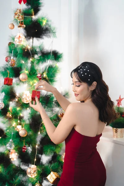 Portrait Pretty Young Girl Decorating Christmas Tree Smiling Wearing Red — Stockfoto
