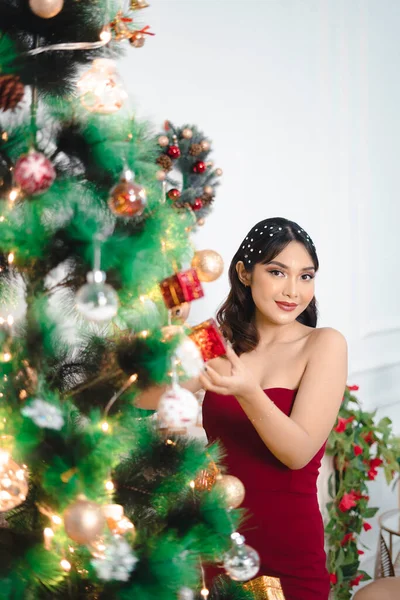 Portrait Pretty Young Girl Decorating Christmas Tree Smiling Wearing Red — Stockfoto