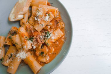 Pennette alla boscaiola - mushrooms tossed with pasta in a silky garlic-herb tomato cream sauce.