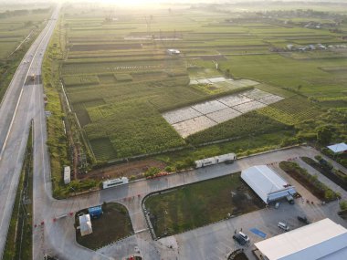 Aerial view of Jalan Raya Indonesia with few cars and sunrise view