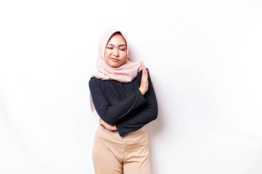 Beautiful Asian Muslim woman wearing a hijab with hand gesture pose rejection or prohibition with copy space