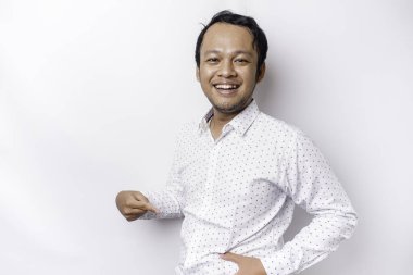 A portrait of insecure Asian fat man is holding the fat on his belly