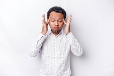A portrait of an Asian man wearing a white shirt isolated by white background looks depressed