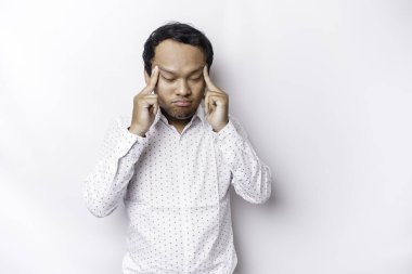 A portrait of an Asian man wearing a white shirt isolated by white background looks depressed