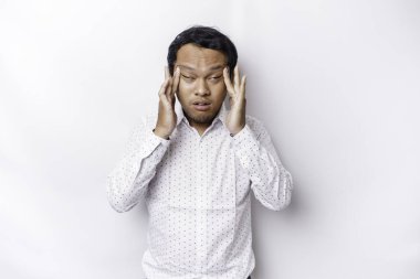 A portrait of an Asian man wearing a white shirt isolated by white background looks depressed