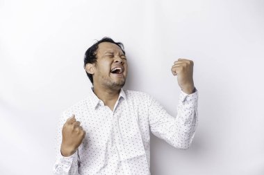 A young Asian man with a happy successful expression wearing white shirt isolated by white background