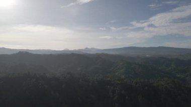 Sunrise over hillside with long sun rays pass through valley in village Bali, Indonesia