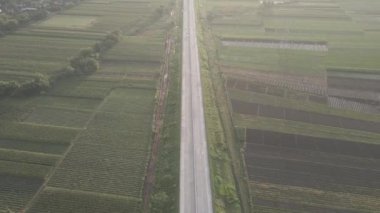 Aerial view of Jalan Raya Indonesia with few cars and sunrise view