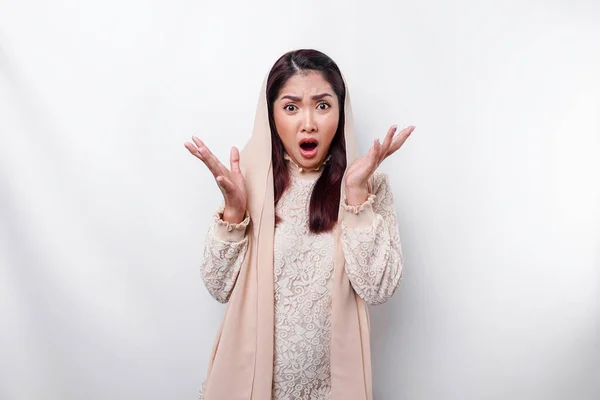 stock image Shocked Asian Muslim woman wearing headscarf with her mouth wide open, isolated by white background