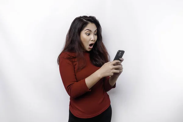 Σοκαρισμένη Ασιάτισσα Κόκκινη Μπλούζα Κρατώντας Τηλέφωνό Της Απομονωμένη Από Λευκό — Φωτογραφία Αρχείου