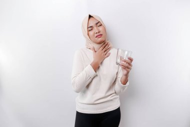 An Asian Muslim woman feels so thirsty because of the hot weather during the summer season while fasting