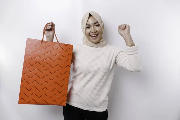 stock image Asian Muslim woman happy beautiful young standing excited holding a shopping bag, studio shot isolated on white background