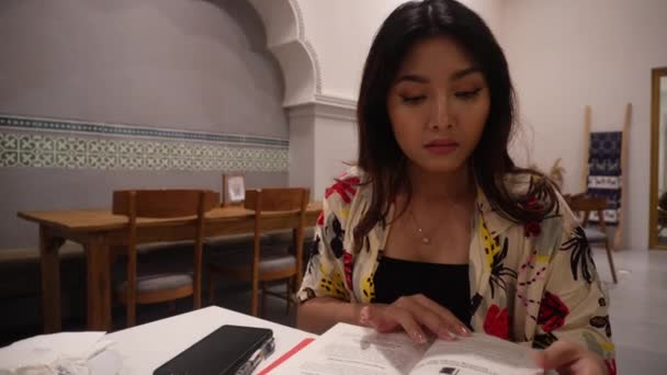 Adorable Asian Woman Sitting Reading Book Restaurant — Stock Video