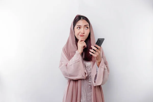 Thoughtful Young Asian Muslim Woman Wearing Hijab Holding Her Chin — Stockfoto